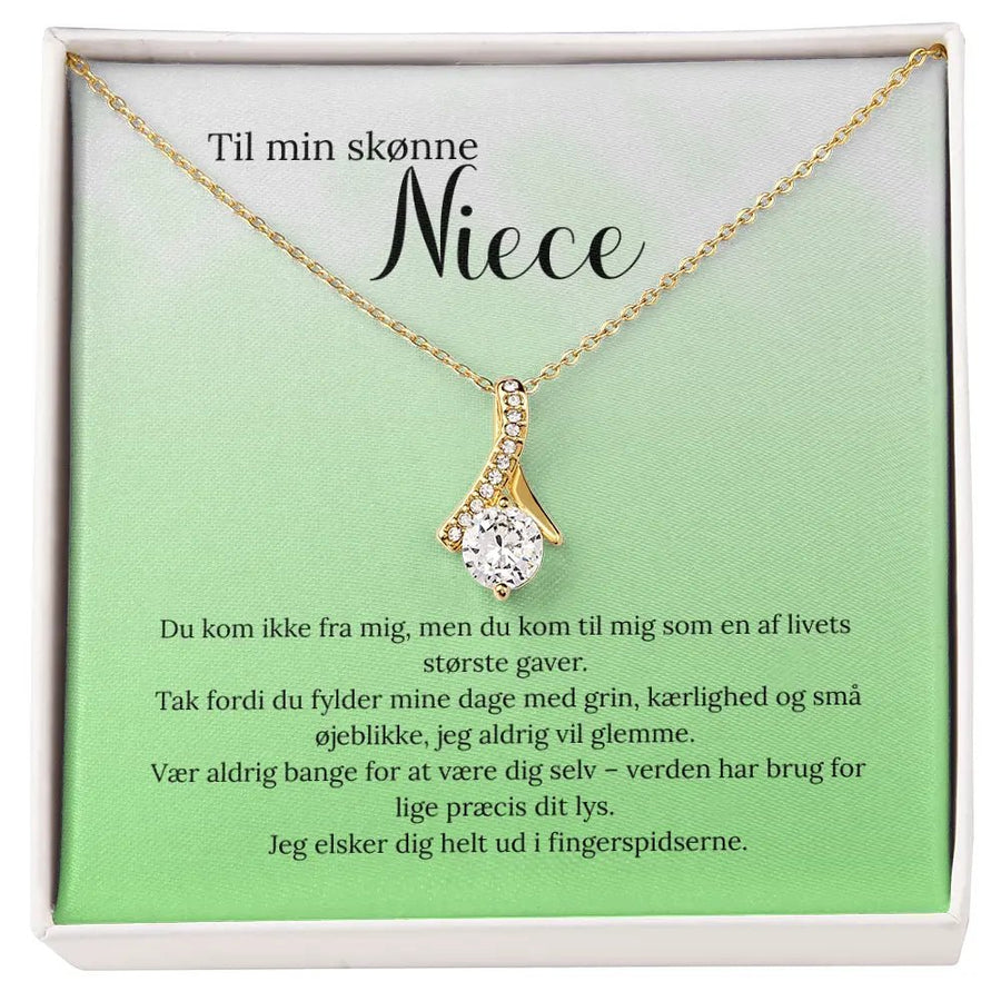 Betydningsfuld gave til niece – elegant guldbelagt smykke med kærlig hilsen fra moster