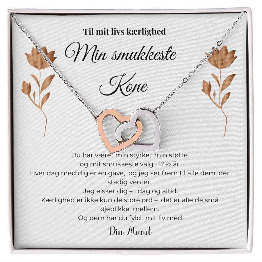 Halskæde med to sammenflettede hjerter i sølv og rosaguld, elegant symbol på kærlighed, kobberbryllupsgave til kone