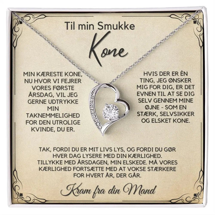 Hjerteformet halskæde i rustfrit stål med 14k hvidguldsbelægning og glitrende sten. En betydningsfuld gave til kone fra mand – ideel til 1-års bryllupsdag.