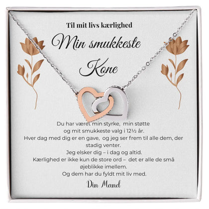 Halskæde med to sammenflettede hjerter i sølv og rosaguld, elegant symbol på kærlighed, kobberbryllupsgave til kone