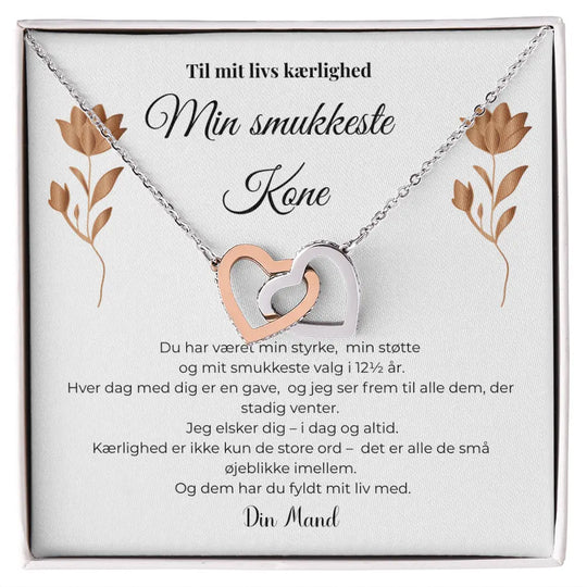 Halskæde med to sammenflettede hjerter i sølv og rosaguld, elegant symbol på kærlighed, kobberbryllupsgave til kone